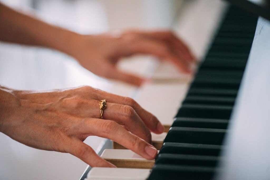 Close-up photo of a female musician playing the piano